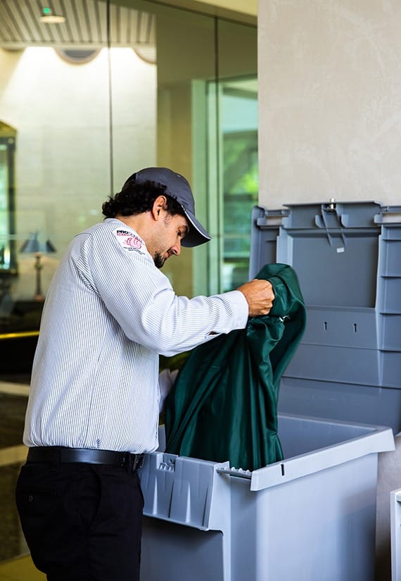 Proshred employee removing the bag inside the secure console bins