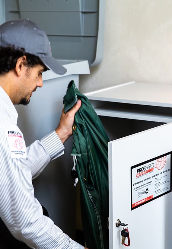 Proshred employee opening up a secure console bin